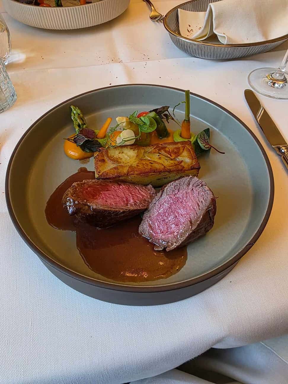 A meat course at the St. Alban-Stübli, served pink with jus and gratin