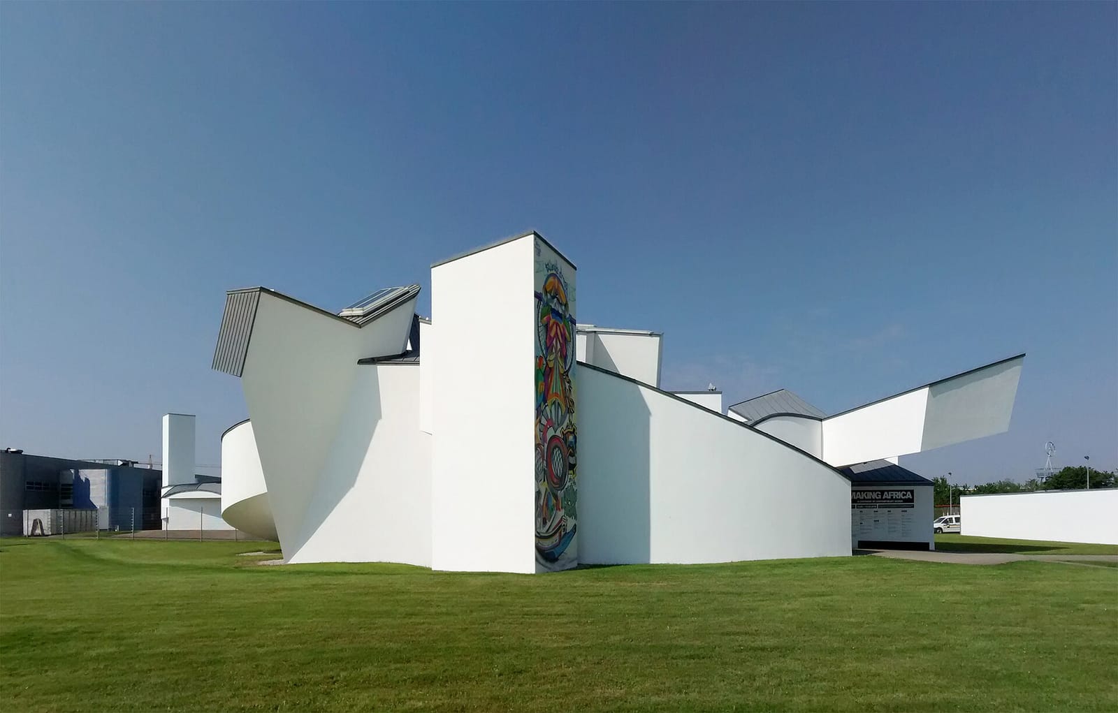 Frank Gehry's white Vitra Design Museum in Weil am Rhein, its interlocking curved volumes set on the lawn