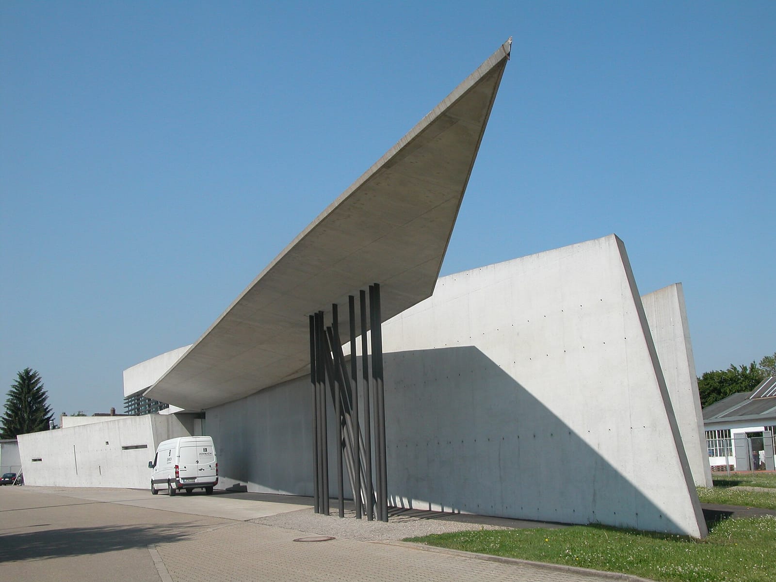 Zaha Hadid's fire station on the Vitra Campus in Weil am Rhein, a sharp-angled concrete building with a far-projecting canopy